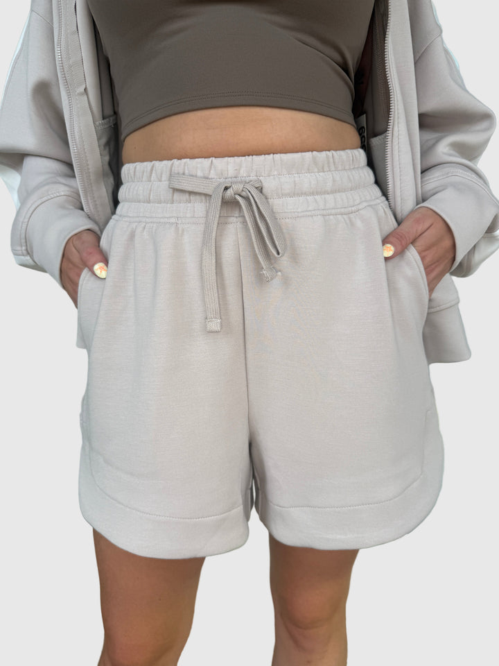 Person wearing a light mocha colored jogger shorts