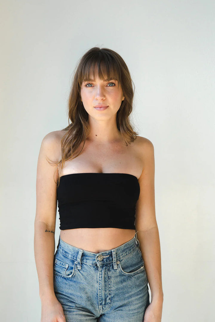 Product shot of NŪD Apparel Hunter Double Layer Bandeau in black paired with  high rise denim, front view.