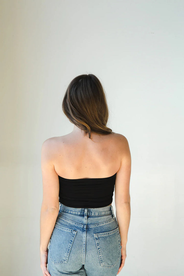 Product shot of NŪD Apparel Hunter Double Layer Bandeau in black paired with  high rise denim, back view.