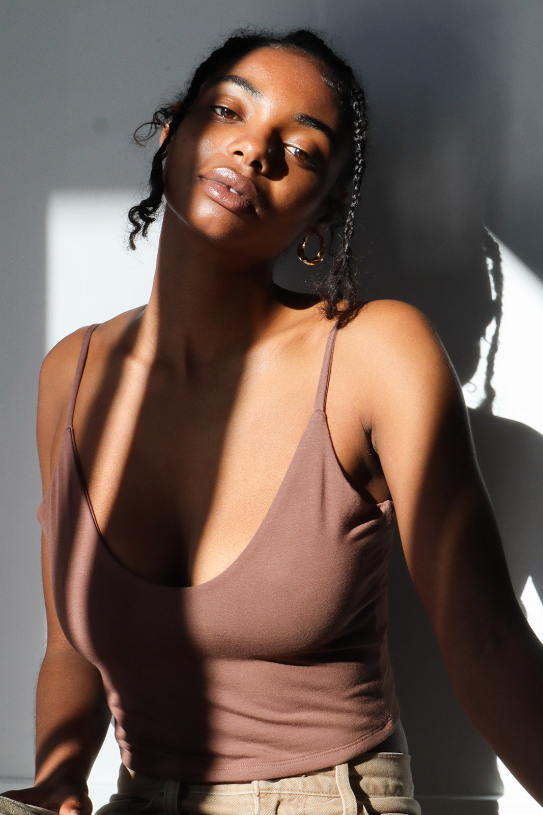 Product shot of NŪD Apparel Kyla Double Layer Crop Tank in dark nude paired with low rise khakis, front view.