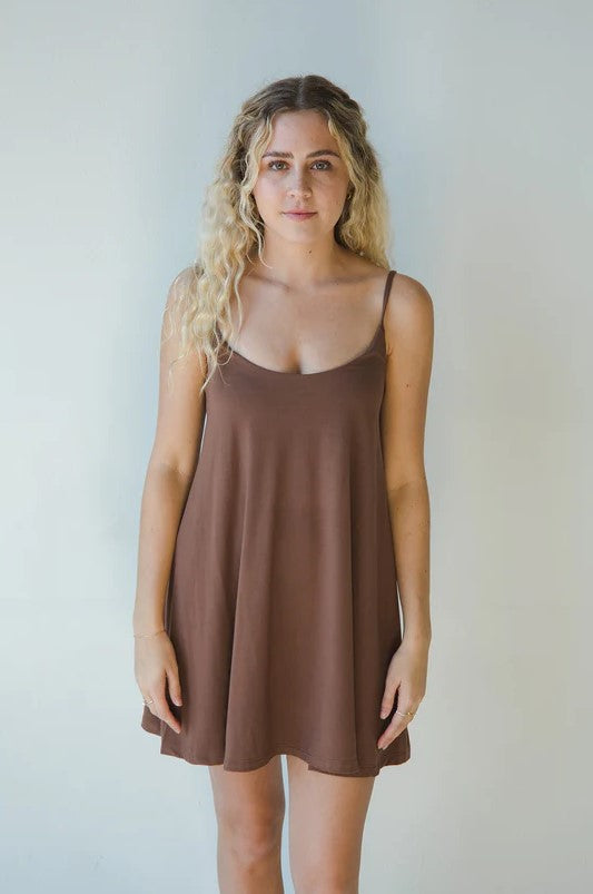 Product shot of NŪD Apparel Betty Swing Dress in dark nude, front view.