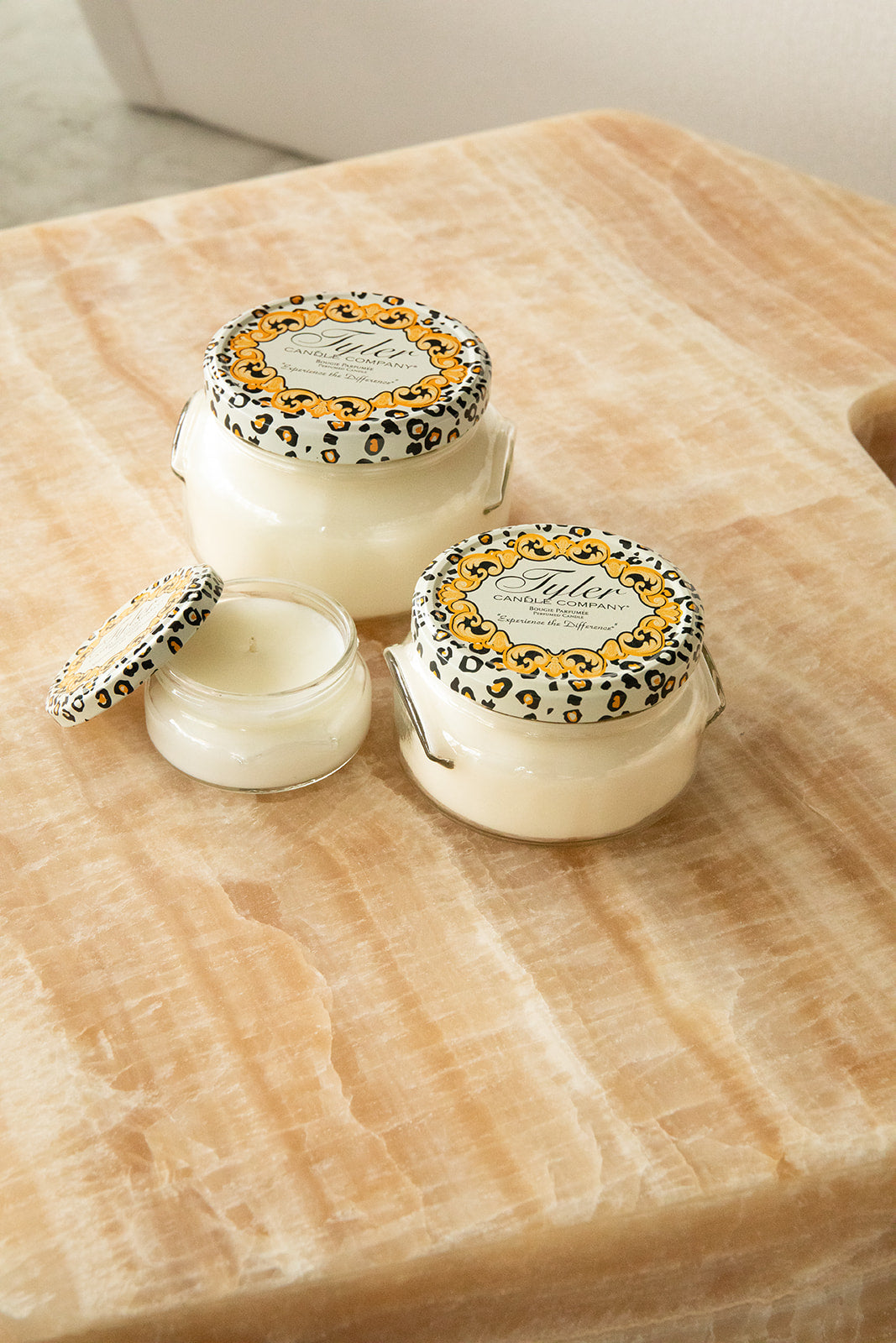 Product shot of Tyler Candle Company candles in 22oz, 11oz, and 3.4oz in scent platinum.