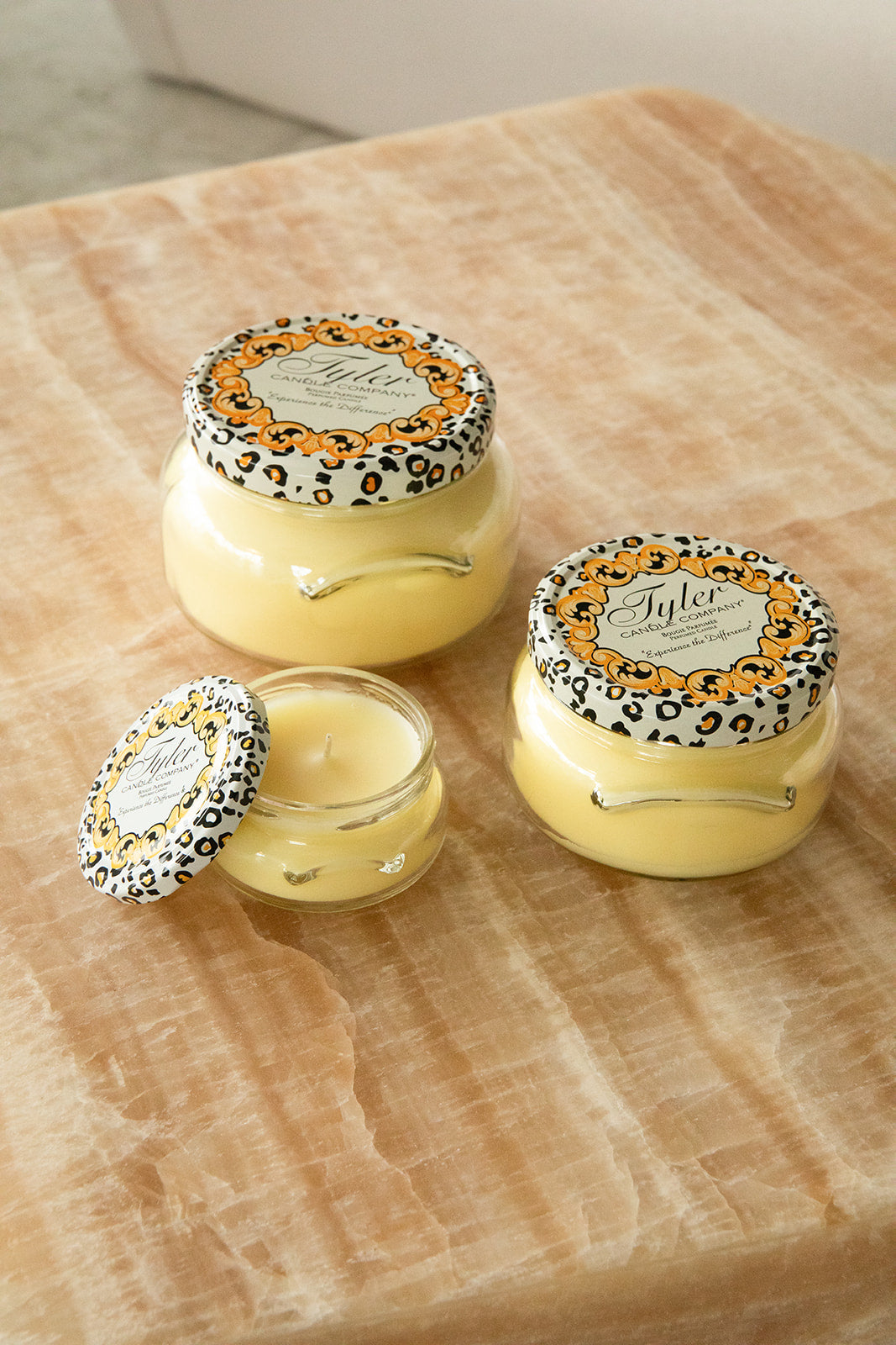 Product shot of Tyler Candle Company candles in 22oz, 11oz, and 3.4oz in scent beach blonde.