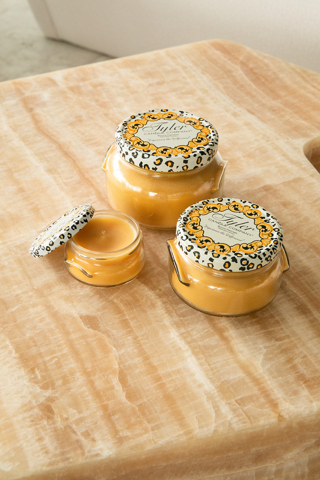 Product shot of Tyler Candle Company candles in 22oz, 11oz, and 3.4oz in scent family tradition.
