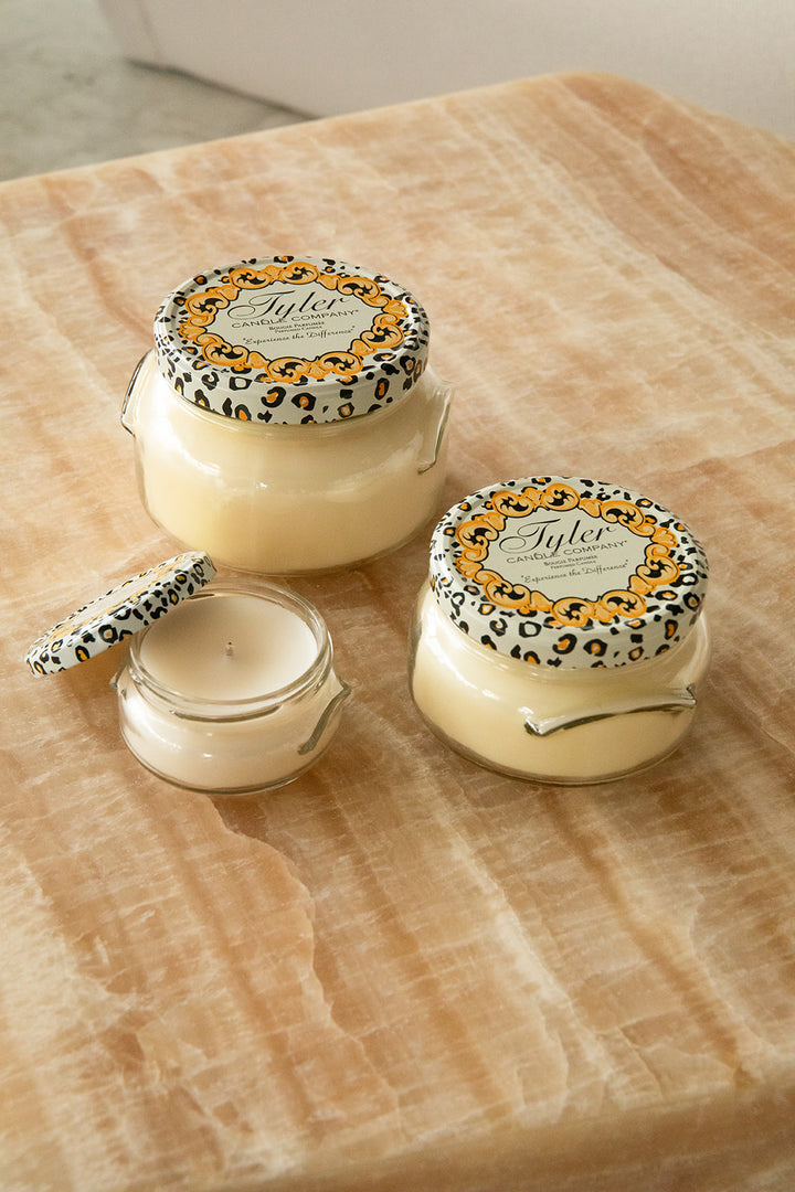 Product shot of Tyler Candle Company candles in 22oz, 11oz, and 3.4oz in scent french market.