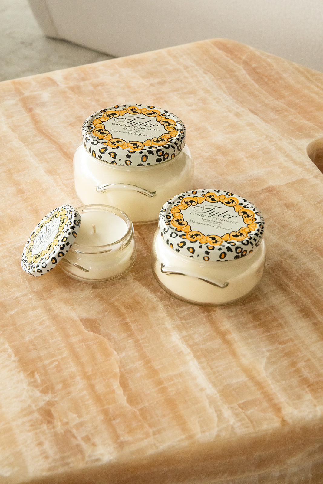 Product shot of Tyler Candle Company candles in 22oz, 11oz, and 3.4oz in scent glamfam.