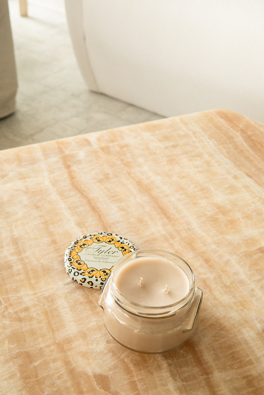 Product shot of Tyler Candle Company 11oz candle in scent high maintenance.