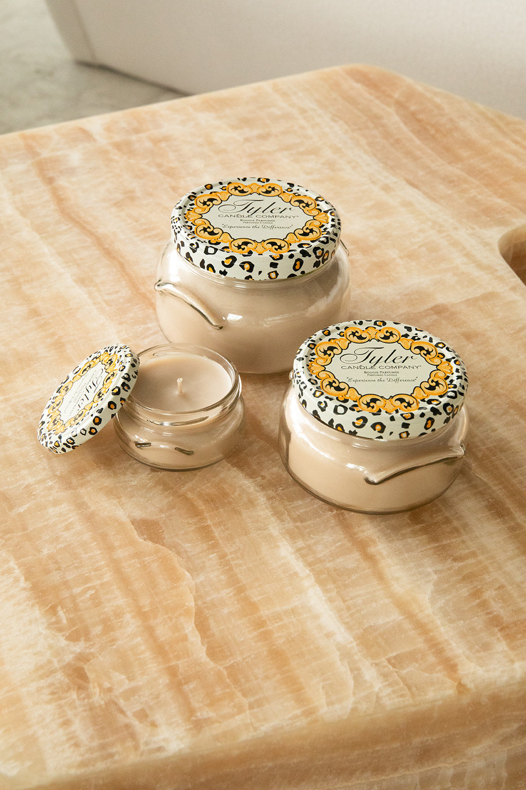 Product shot of Tyler Candle Company candles in 22oz, 11oz, and 3.4oz in scent high maintenance.