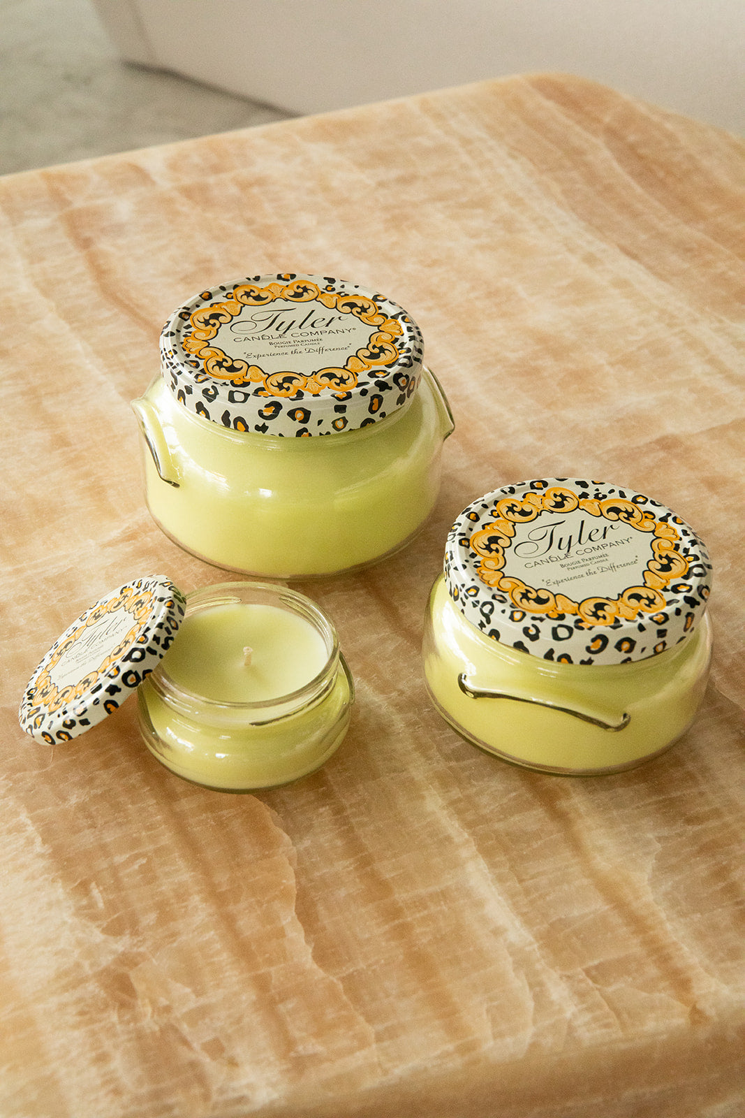 Product shot of Tyler Candle Company candles in 22oz, 11oz, and 3.4oz in scent limelight.