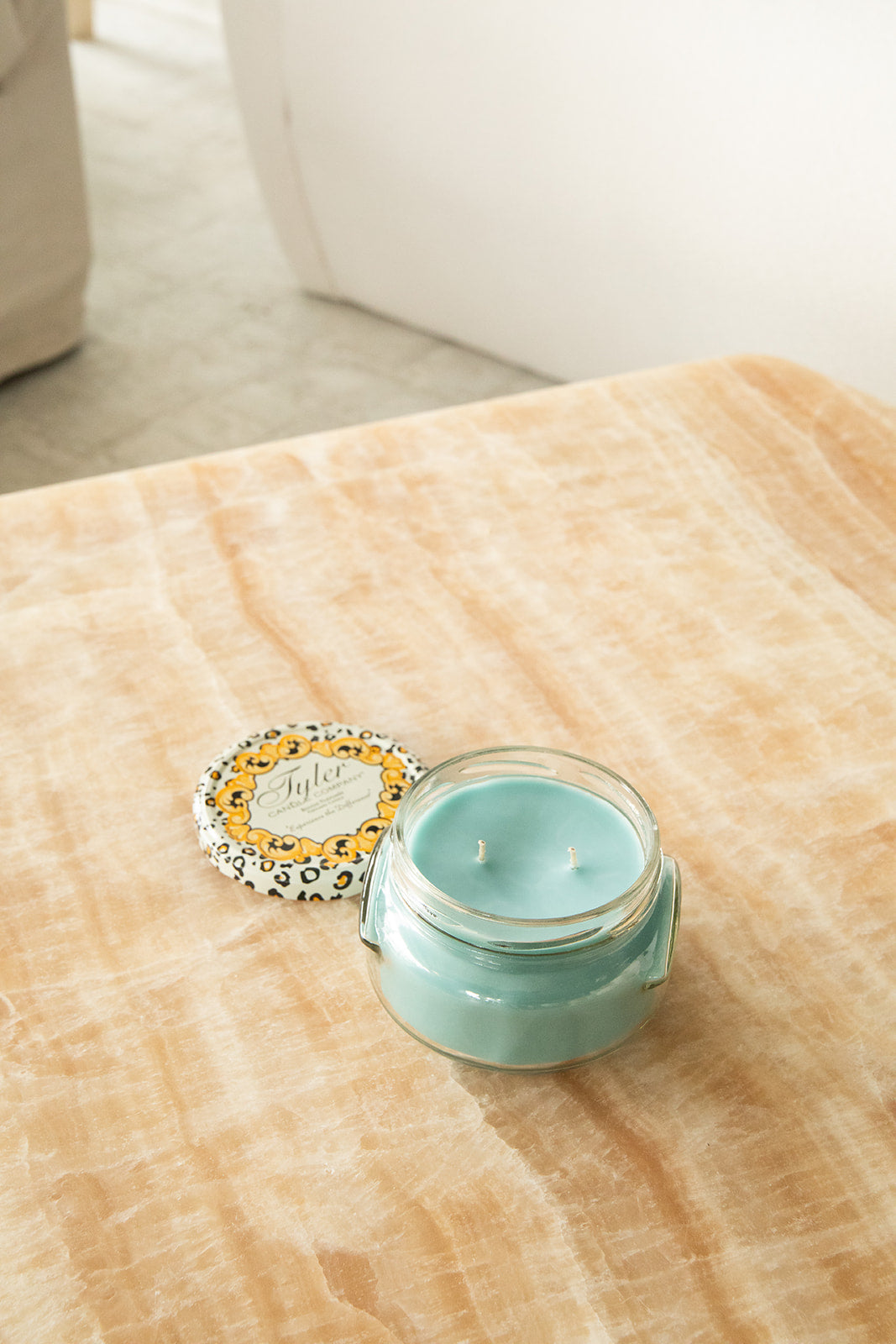 Product shot of Tyler Candle Company 11oz candle in scent resort.