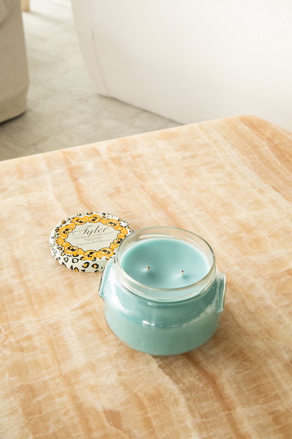 Product shot of Tyler Candle Company 22oz candle in scent resort.