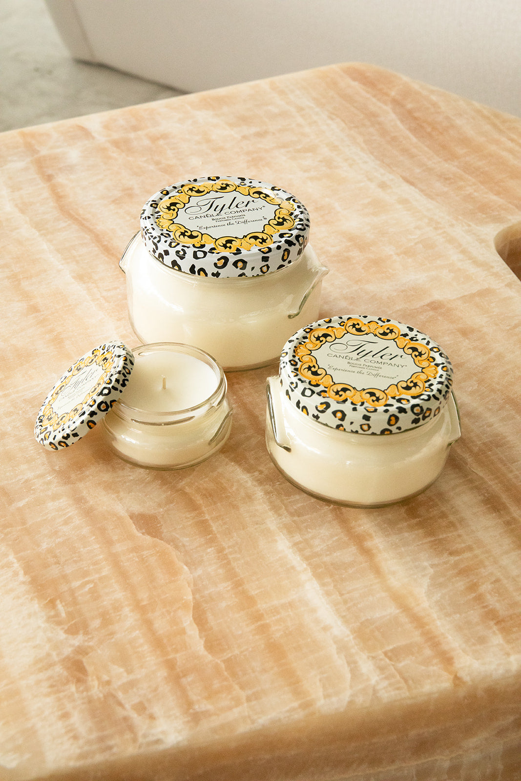 Product shot of Tyler Candle Company candles in 22oz, 11oz, and 3.4oz in scent winter wonderland.