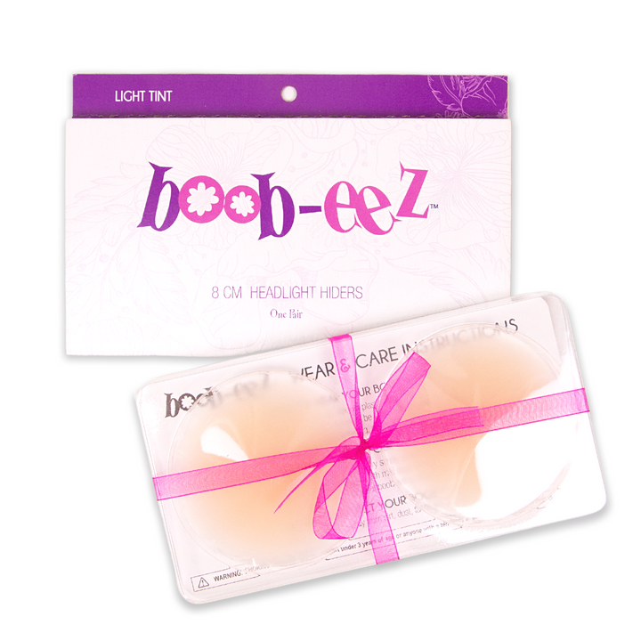 Product shot of Boob-eez 8cm light tint nipple covers in craft packaging.