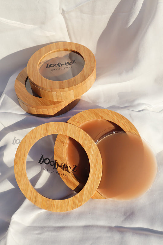 Product shot of Boob-eez Nipple Cover Compacts on white background.