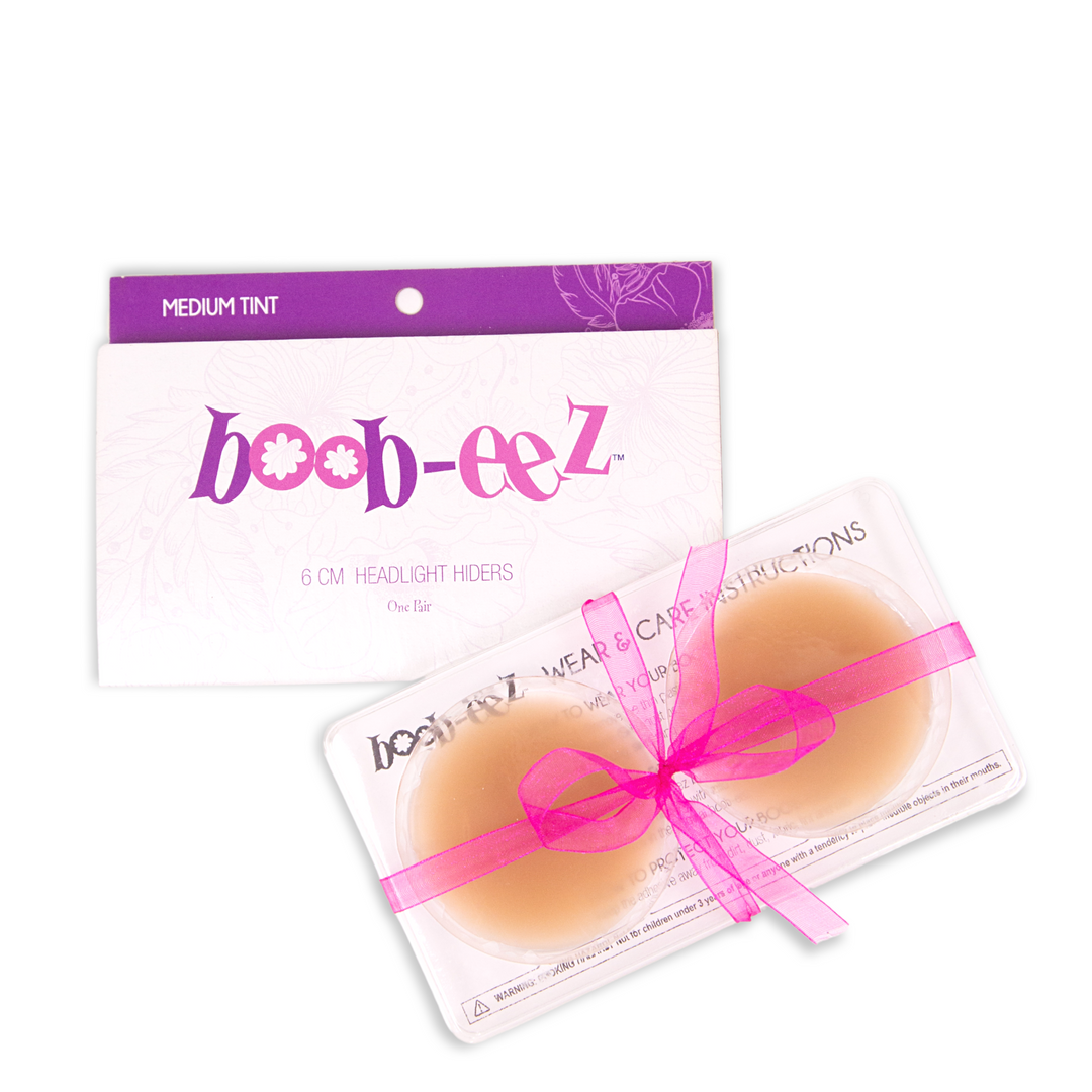 Product shot of Boob-eez 6cm medium tint nipple covers in craft packaging.