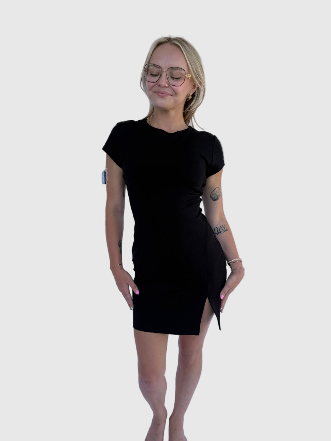 Person wearing a black dress lying on a white background