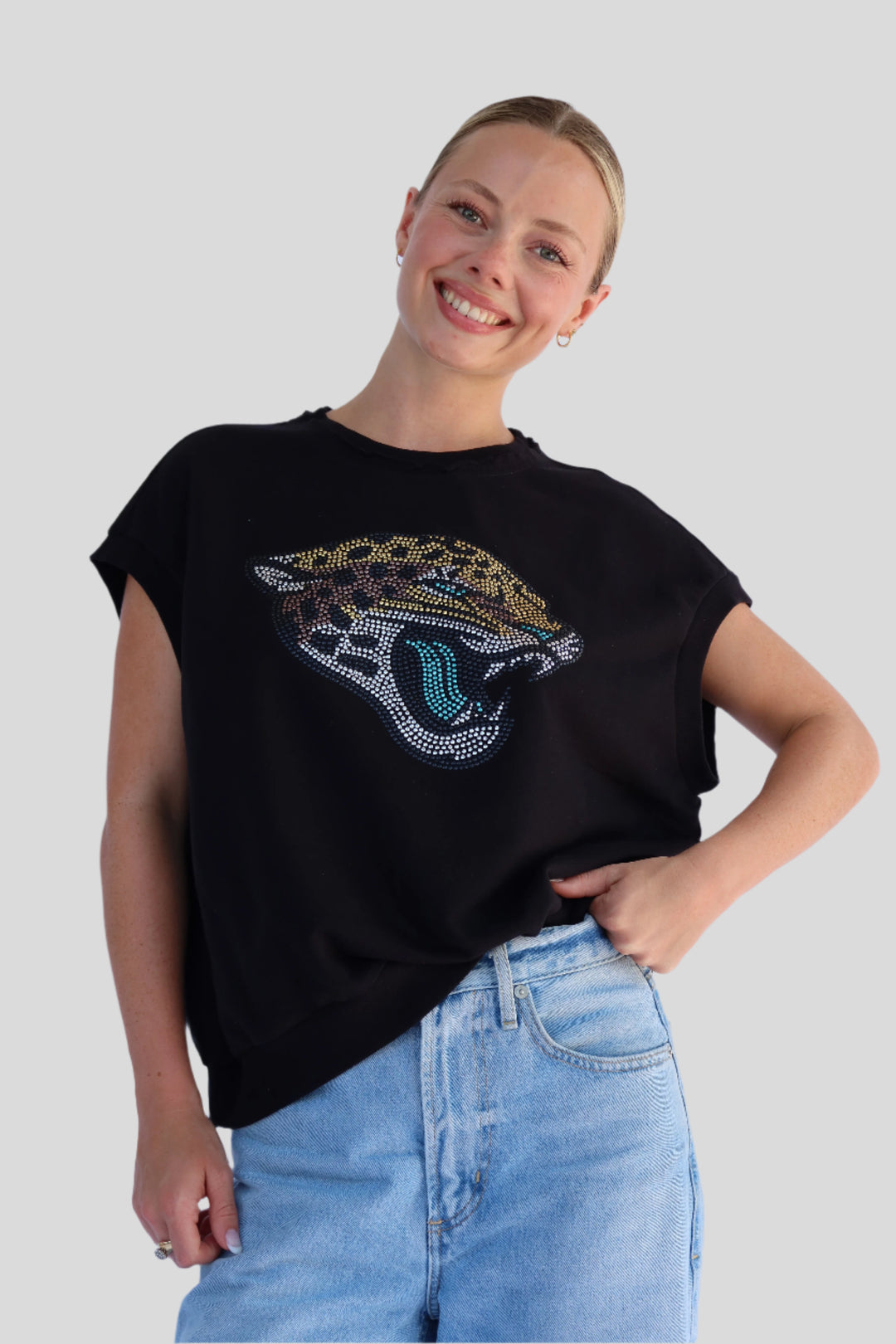 Person wearing a black t-shirt with a Jaguar graphic on a light background