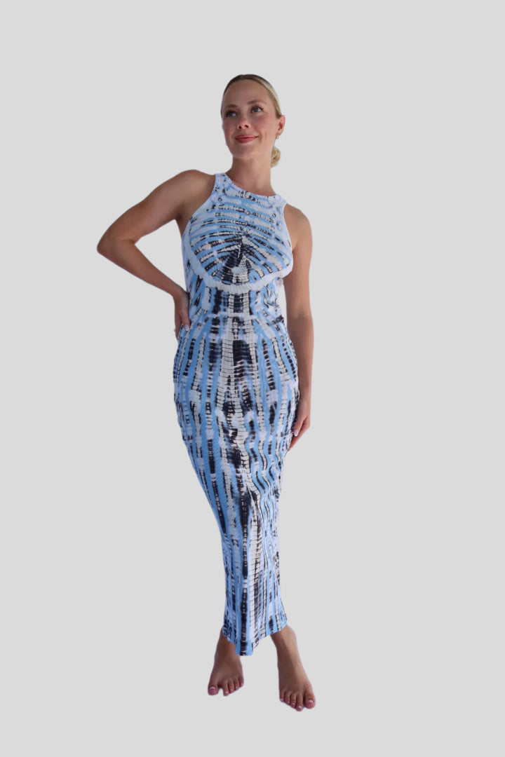 Woman wearing a tie-dye dress against a white background