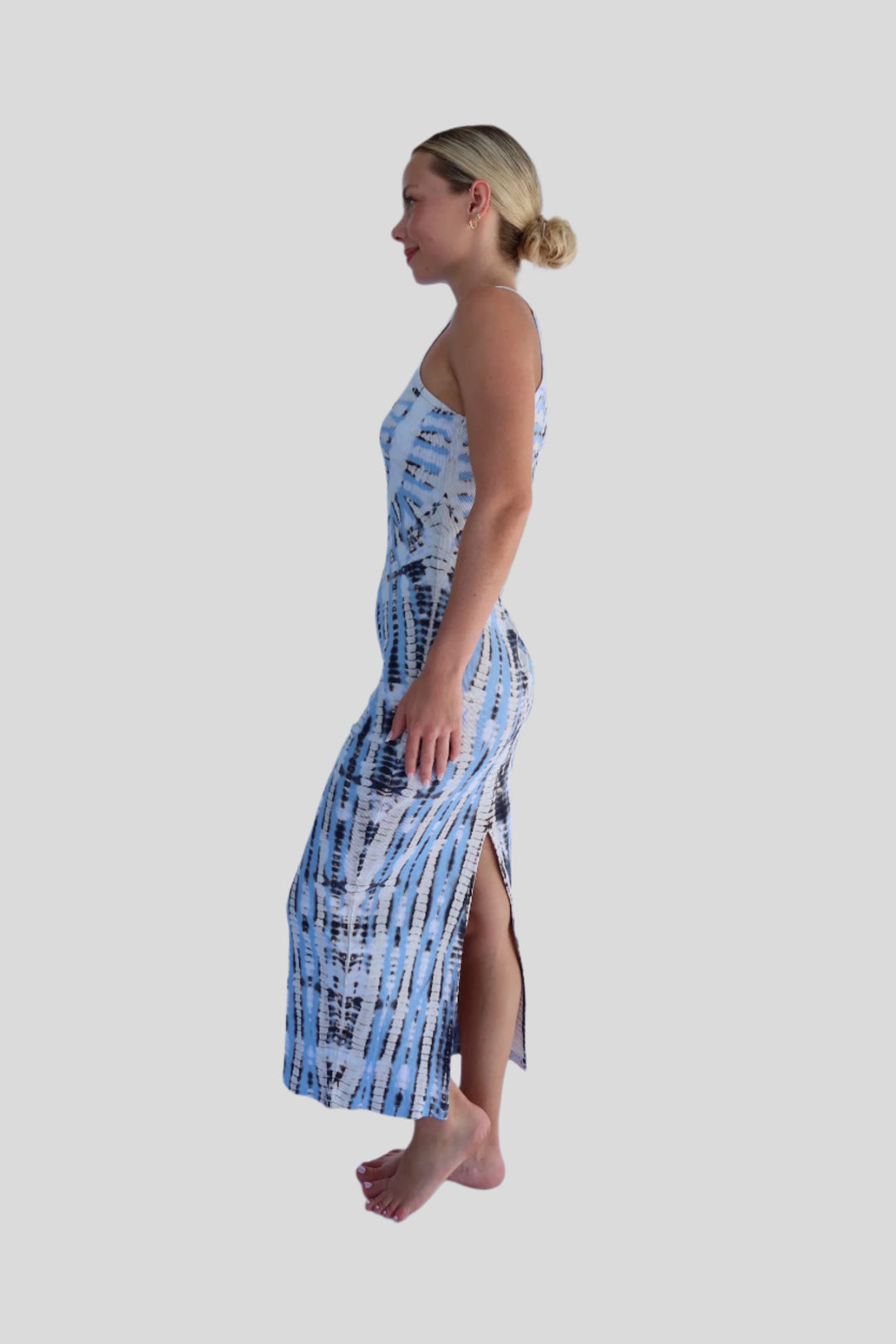 Woman wearing a blue and white patterned dress on a light blue background