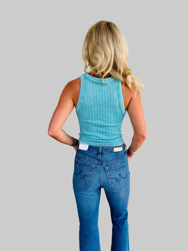 Rear view of Woman wearing teal ribbed tank top with Jaguar game day patch