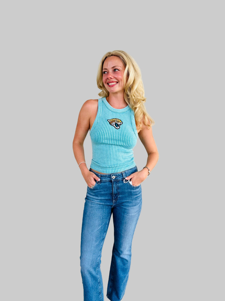 Woman wearing teal ribbed tank top with Jaguar game day patch