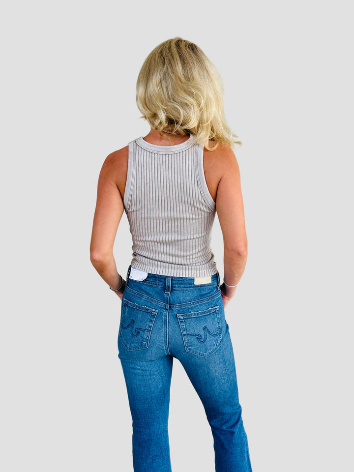 Rear view of woman wearing a tan ribbed tank with Jacksonville Jaguar logo patch