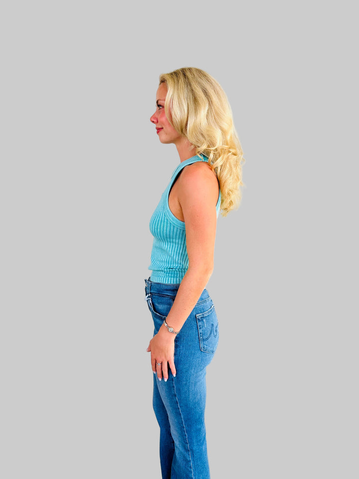 Side view of woman wearing teal ribbed tank top with Jaguar game day patch