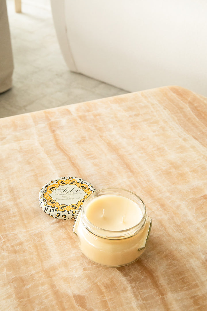Product shot of Tyler Candle Company 11oz candle in scent homecoming.