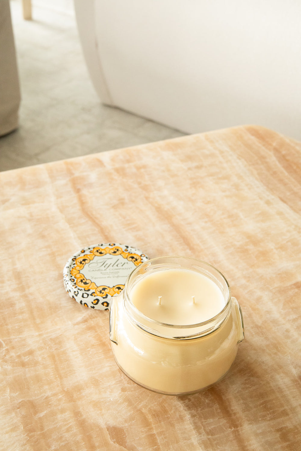 Product shot of Tyler Candle Company 22oz candle in scent homecoming.