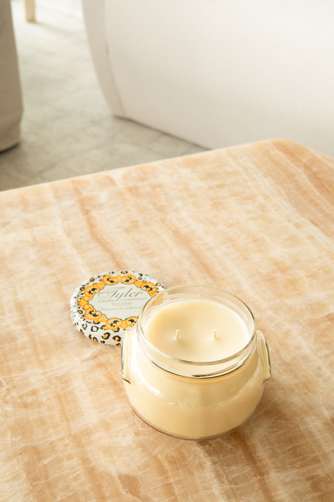Product shot of Tyler Candle Company 22oz candle in scent homecoming.
