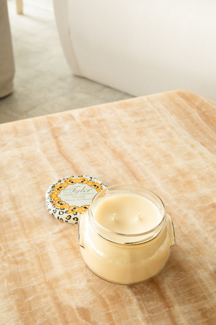 Product shot of Tyler Candle Company 22oz candle in scent homecoming.