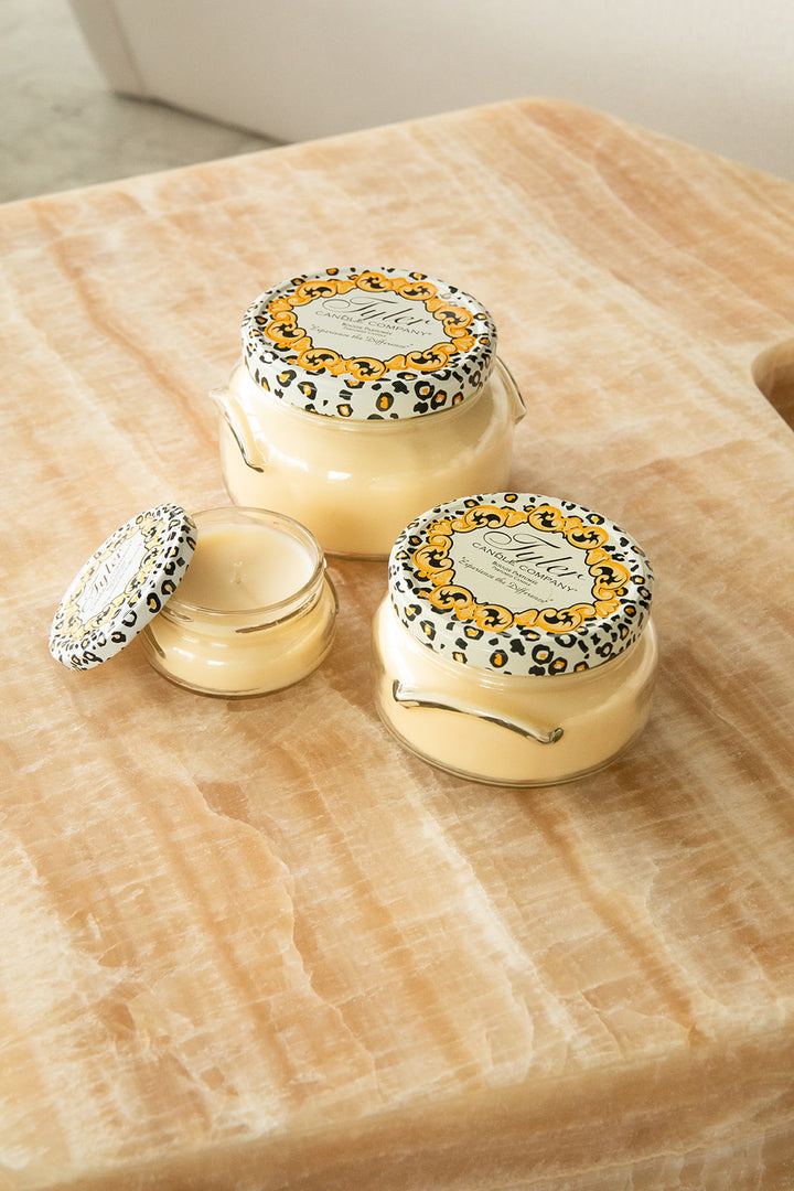 Product shot of Tyler Candle Company candles in 22oz, 11oz, and 3.4oz in scent homecoming.