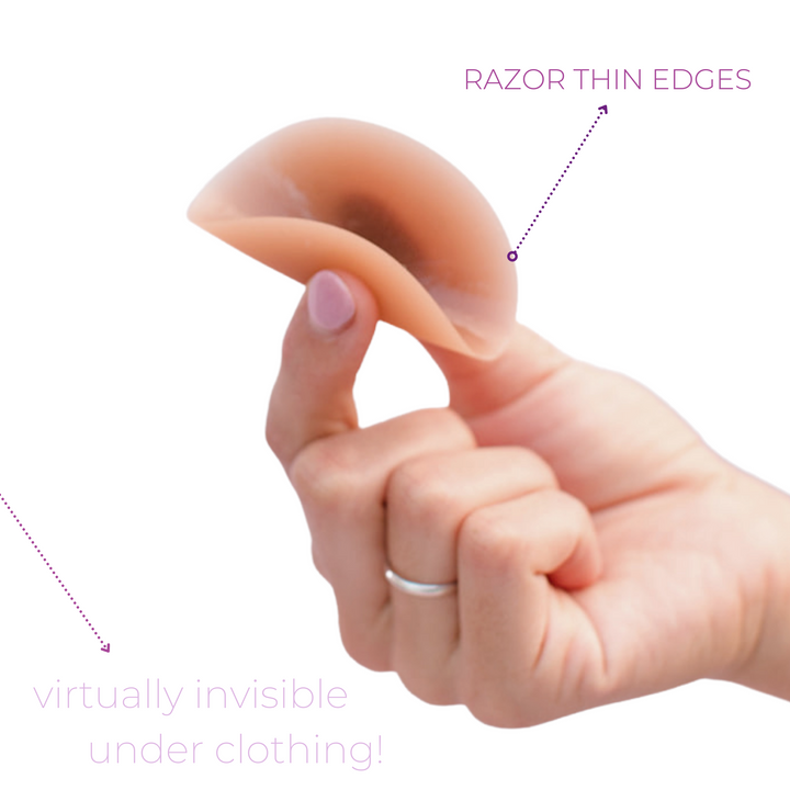 Product shot of Boob-eez 8cm dark tint nipple covers displaying razor thin edges.