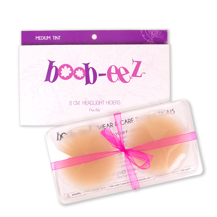 Product shot of Boob-eez 8cm medium tint nipple covers in craft packaging.
